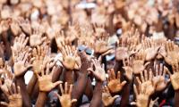 people reaching their hands in the air